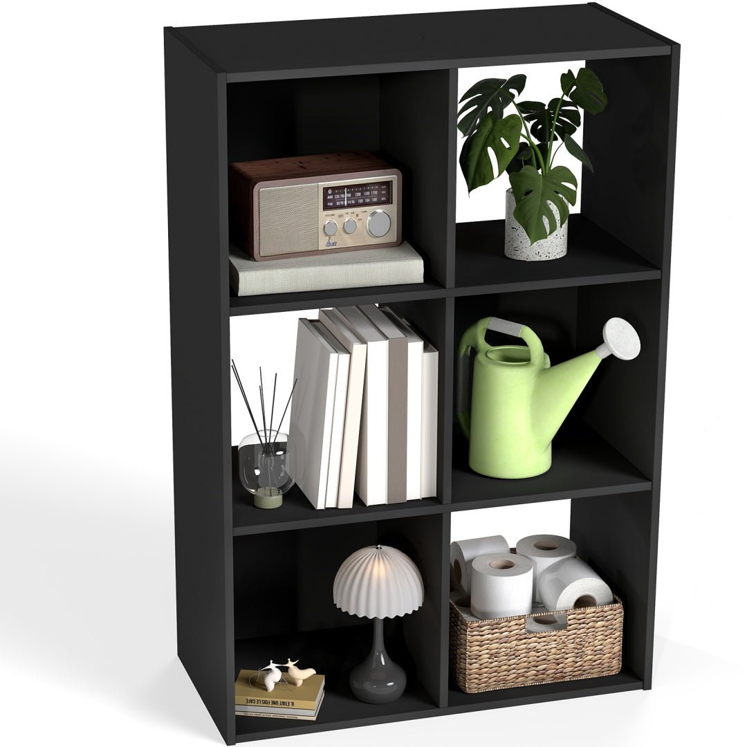 Black cube bookshelf with various items on a white background