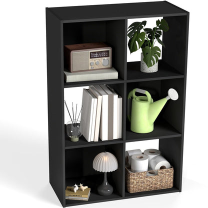Black cube bookshelf with various items on a white background