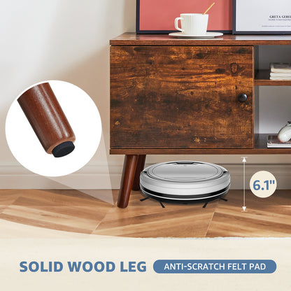 Robotic vacuum cleaner on a wooden floor with a wooden cabinet in the background