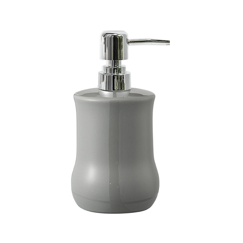 Gray soap dispenser with a silver pump on a white background