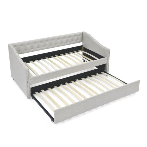 Gray bed frame with a pull-out trundle on a white background