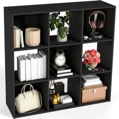 Black cube shelf with various items including books, a plant, headphones, and decorative objects.