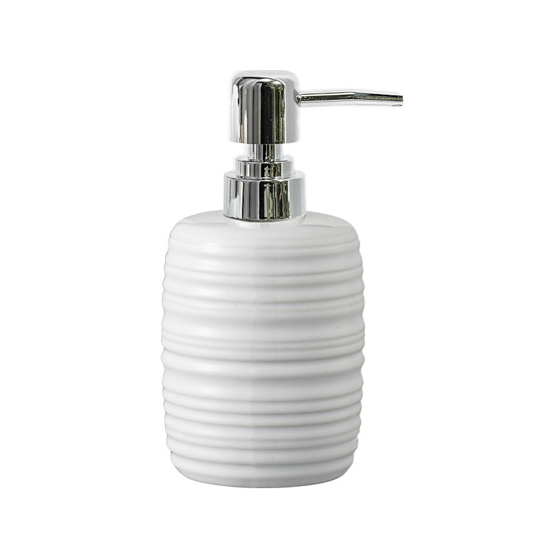 White ceramic soap dispenser with a silver pump on a white background