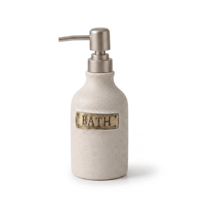 A textured ceramic bath soap dispenser bottle with a brushed metal pump and a brass 'BATH' label on the front, set against a plain white background.