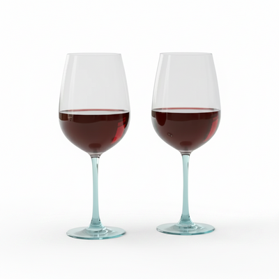 Two wine glasses filled with red wine on a white background
