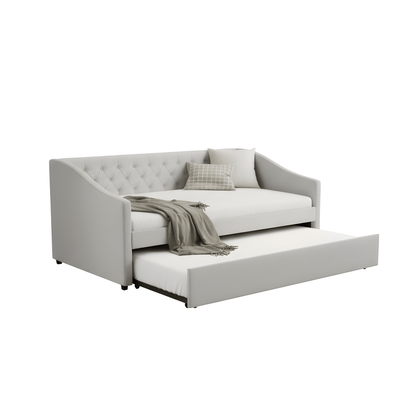 Gray sofa bed with a tufted backrest and a blanket on a white background