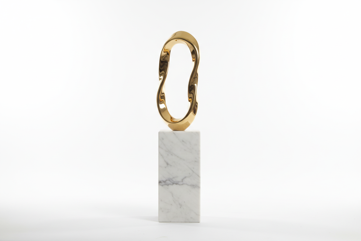 Gold ring on a marble block against a white background