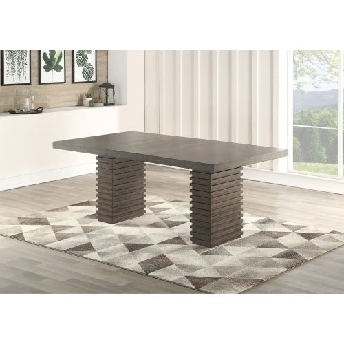 Dining table with unique leg design in a room with a window and decor.