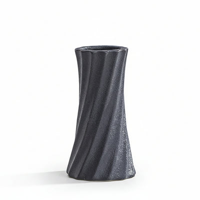 A dark gray textured ceramic vase with a twisted spiral design, shown on a light gray surface with text overlay detailing its dimensions.