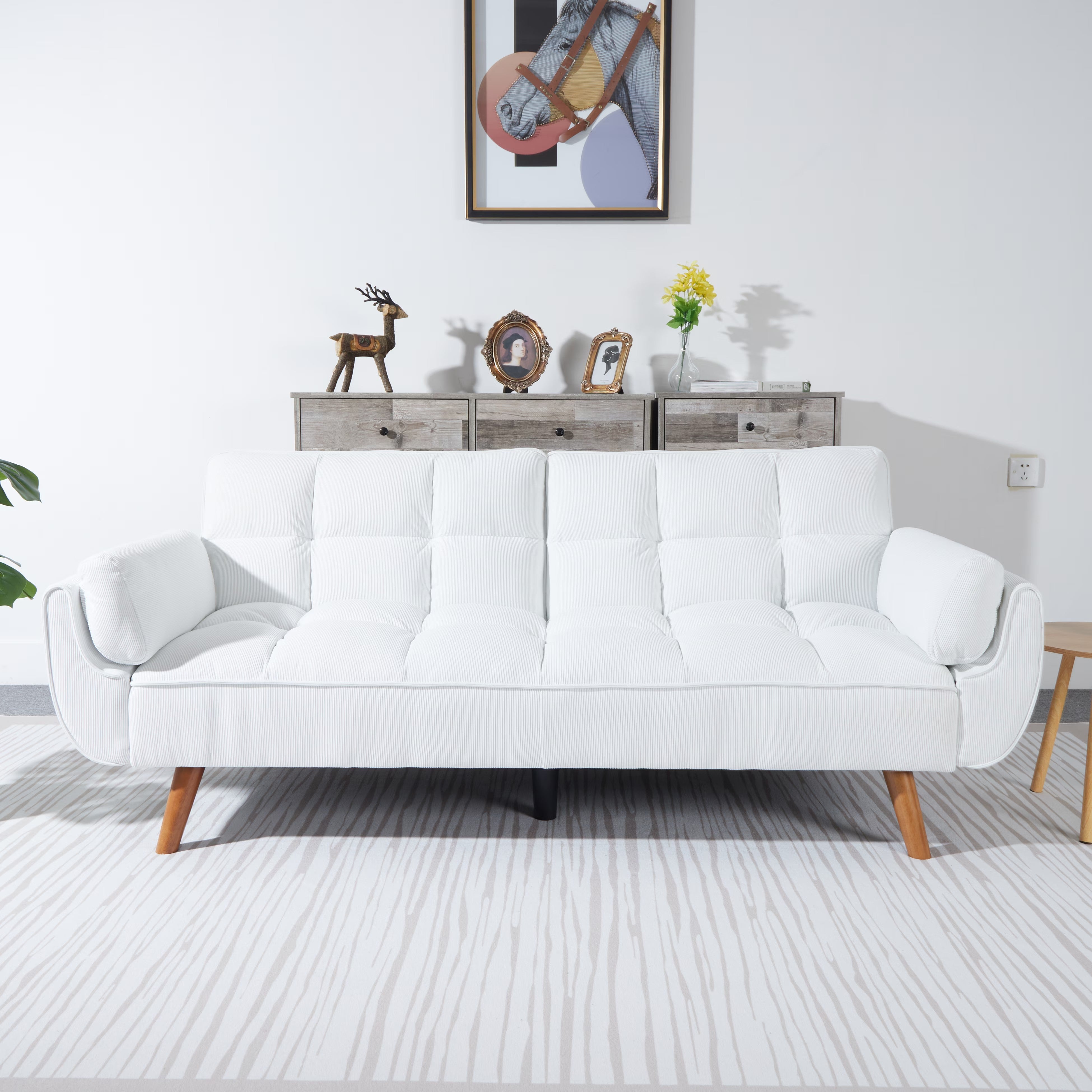 White sofa in a living room with a decorative wall and furniture.