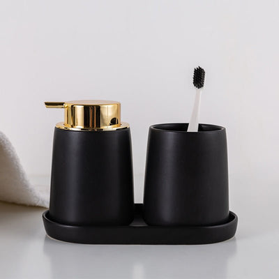 Matte black stone bathroom set with two dispensers and cup, gold pumps – TableFab