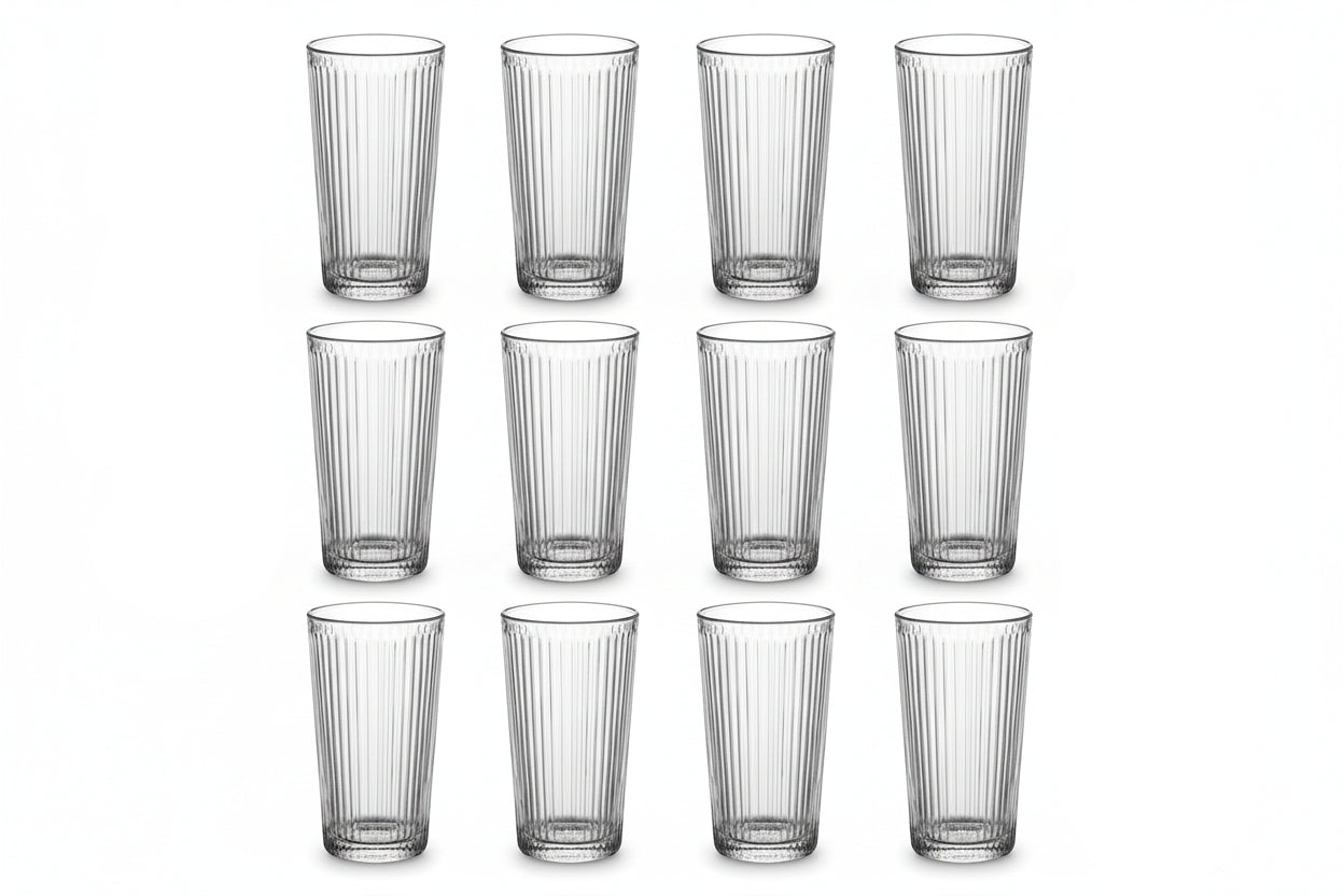 Set of twelve clear glass tumblers with vertical ridges on a white background