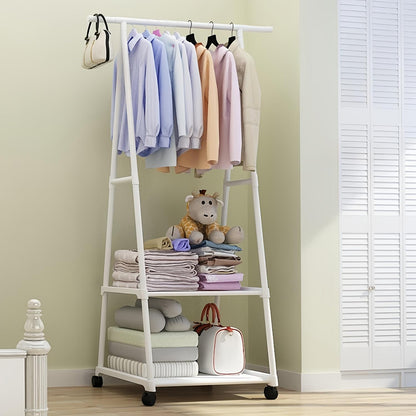 White clothing rack with clothes, toys, and bags against a light green wall.