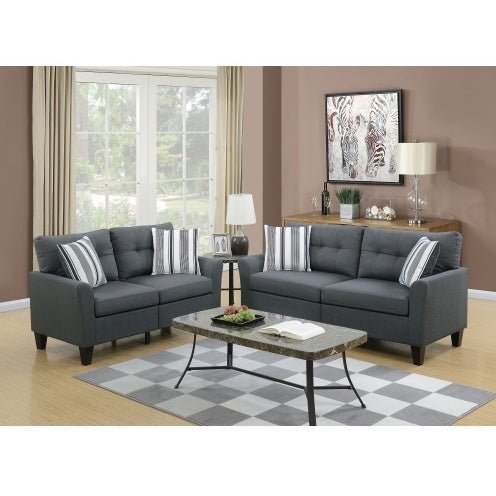Gray sofa set in a living room with a coffee table and decorative items.