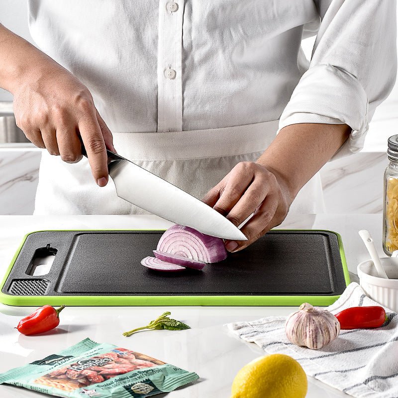 Double-sided cutting board with knife sharpener, showing vegetable slicing in a modern kitchen setting.