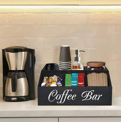 Coffee bar set with coffee maker and organized supplies on a kitchen counter.
