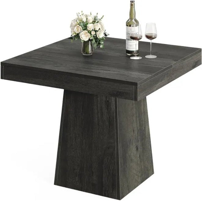 Dark wooden dining table with a vase of flowers and wine bottle on a white background