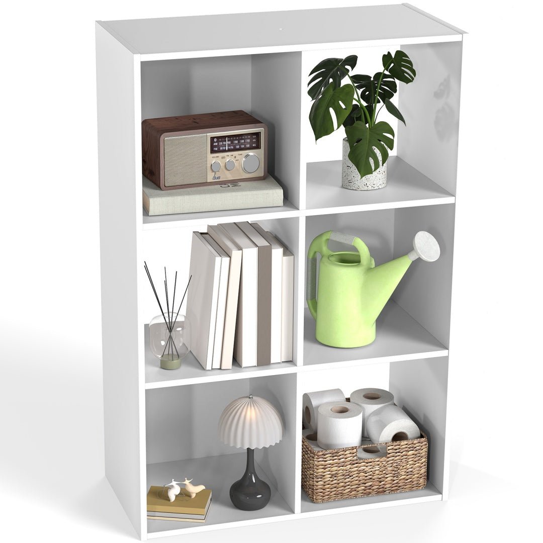 White bookshelf with various items including books, a radio, and decorative objects.