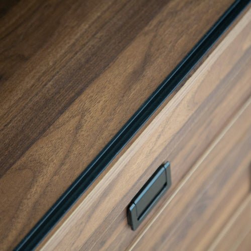 Close-up of a wooden cabinet with a black handle