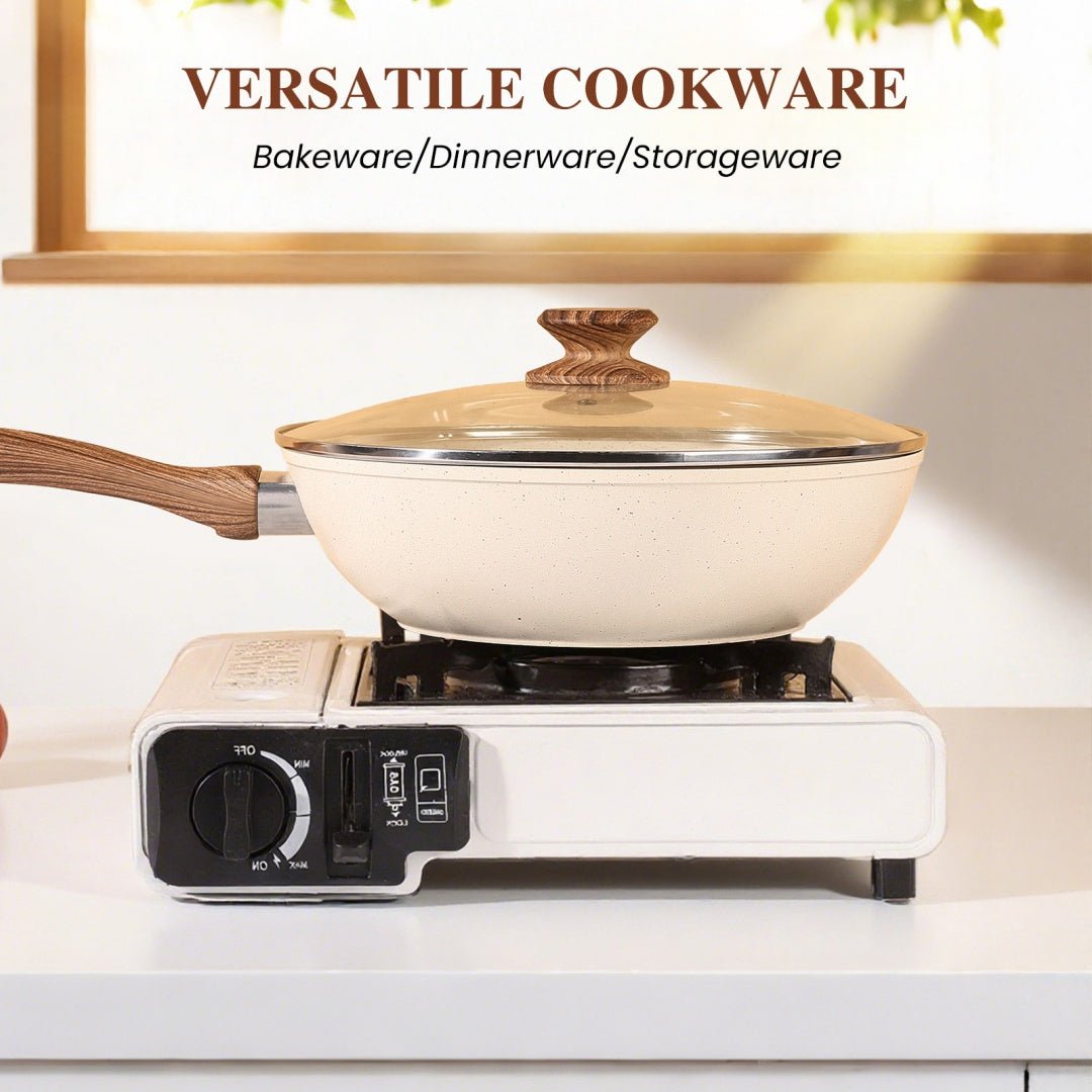 White frying pan with wooden handle and lid on a portable electric stove, with 'VERSATILE COOKWARE' text above.