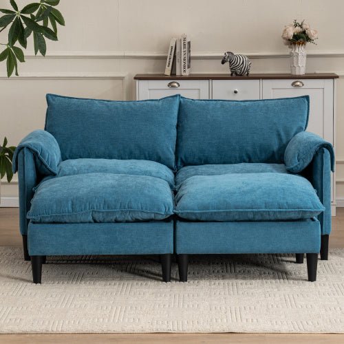 Blue sofa in a living room setting with a cabinet and decor items.