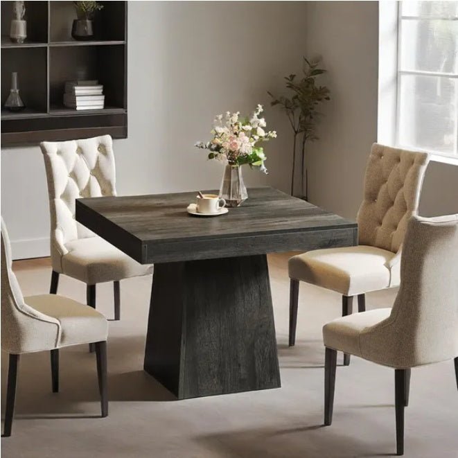 Dining room with a dark wooden table and chairs in a well-lit room.