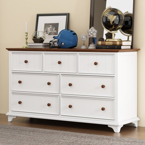 White dresser with wooden top against a beige wall, featuring decorative items.