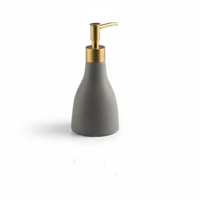 Gray soap dispenser with gold pump and measurements on a white background