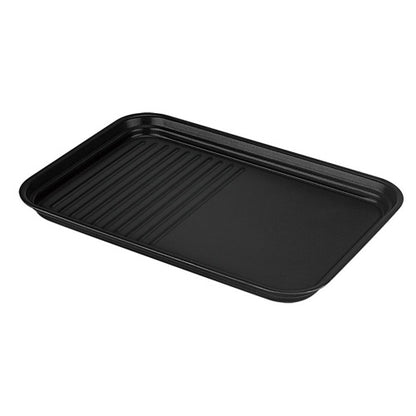 Black baking tray with ribbed surface on a white background