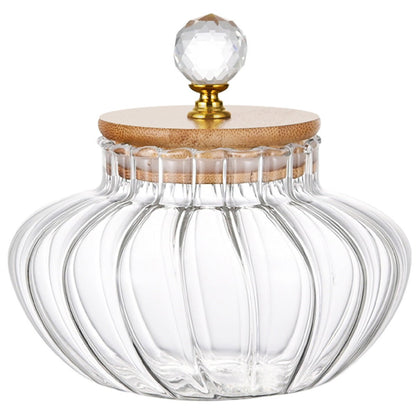 Clear glass jar with a wooden and crystal lid on a white background