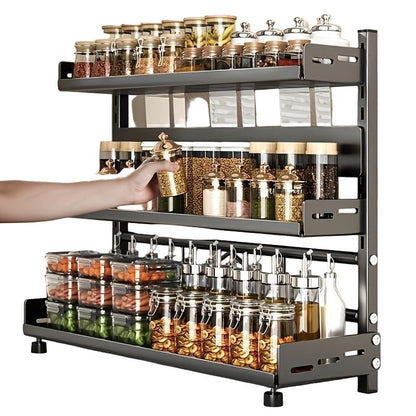 Spice rack with various jars of spices on a kitchen counter.