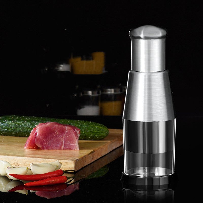Garlic crusher and onion chopper with stainless steel blades, ergonomic handle, on kitchen countertop.